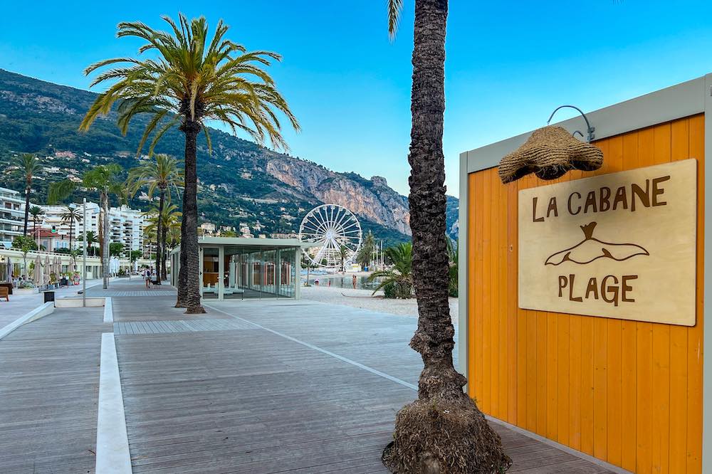 Private beaches at Rondelli Beach in Menton along the Promenade de la Mer and with the Ferris wheel in the backdrop