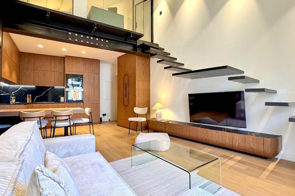 Sleek interior with wood and black finishes of a duplex condo