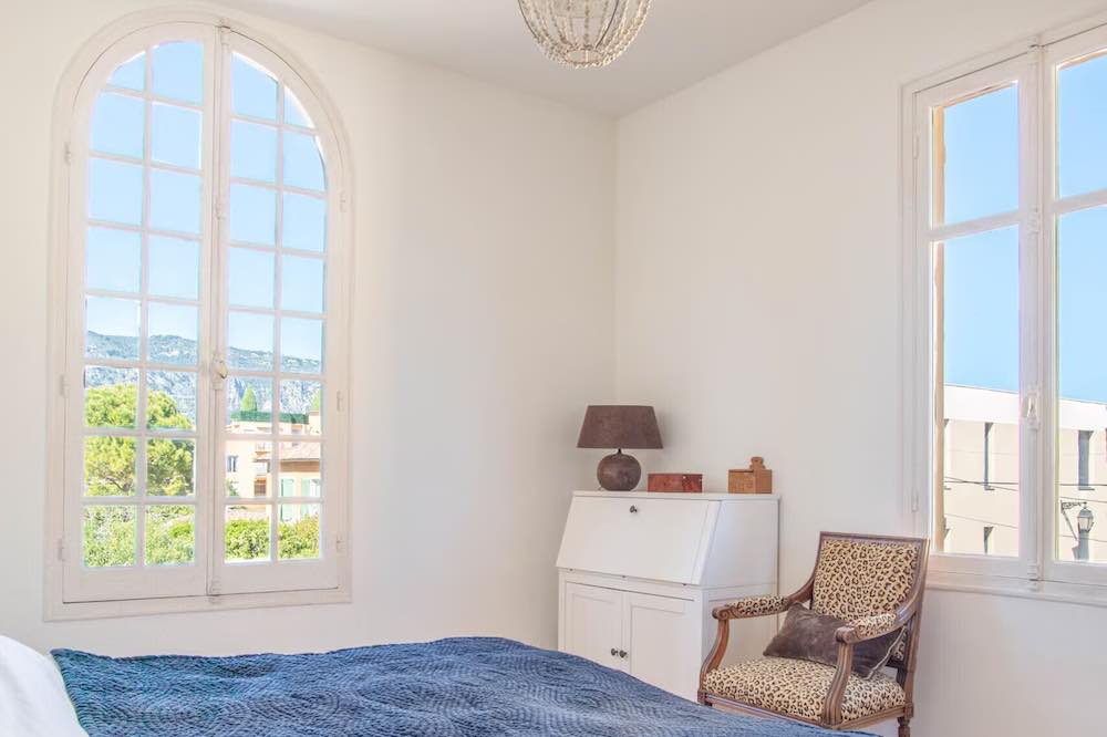 Light and airy bedroom with views over a leafy town