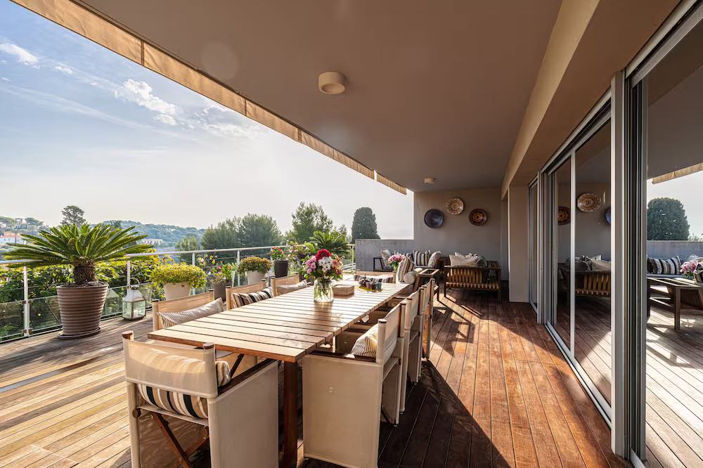 Large wooden deck with garden dining table and panoramic views