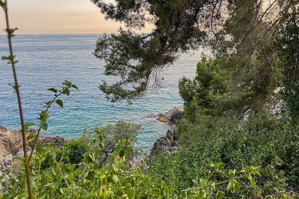 Stone stairs to turquoise waters along the Cap Martin coastal path