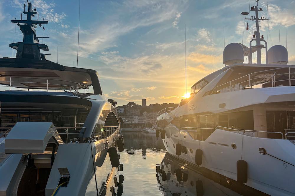 Sunset over Le Suquet seen from between the yachts in the Vieux Port of Canne