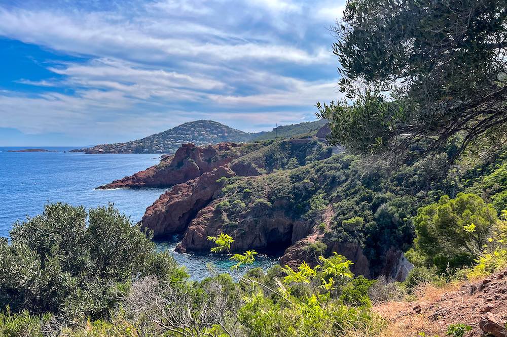 Red cliffs of the Estérel Massif above the turquoise Mediterranean along the Corniche d'Or