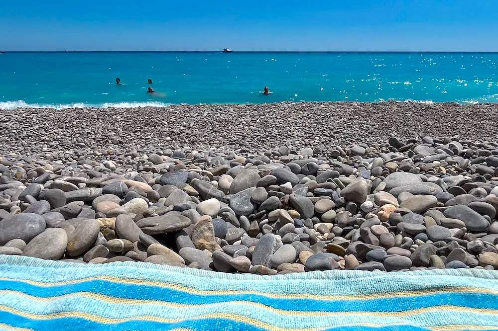 Close-up of smooth grey pebbles on a Nice beach along the Promenade des Anglais