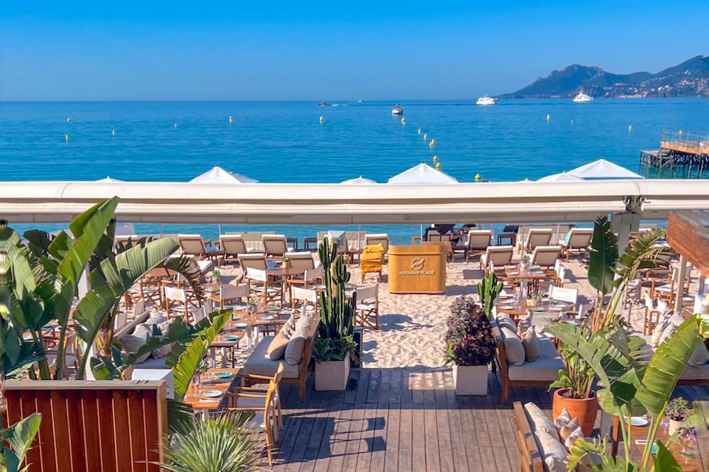 Cream-colored loungers and umbrellas at Miramar Beach club in Cannes